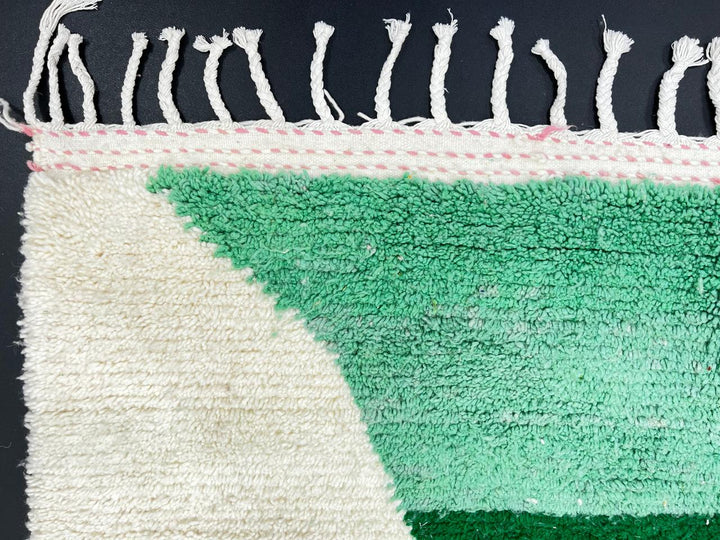 Modern Moroccan wool rug with pink and green hourglass geometric design, handmade by Berber artisans