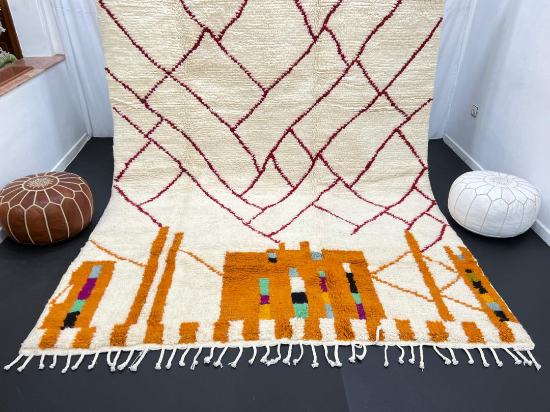 Modern Moroccan wool rug with abstract burgundy lines and golden geometric pattern on a white background