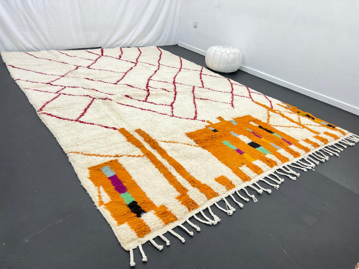 Modern Moroccan wool rug with abstract burgundy lines and golden geometric pattern on a white background