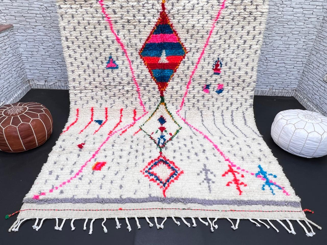 Handmade Moroccan Berber rug with colorful diamond motif on white wool background