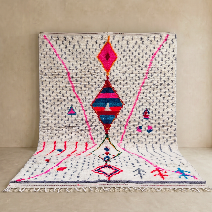 Handmade Moroccan Berber rug with colorful diamond motif on white wool background
