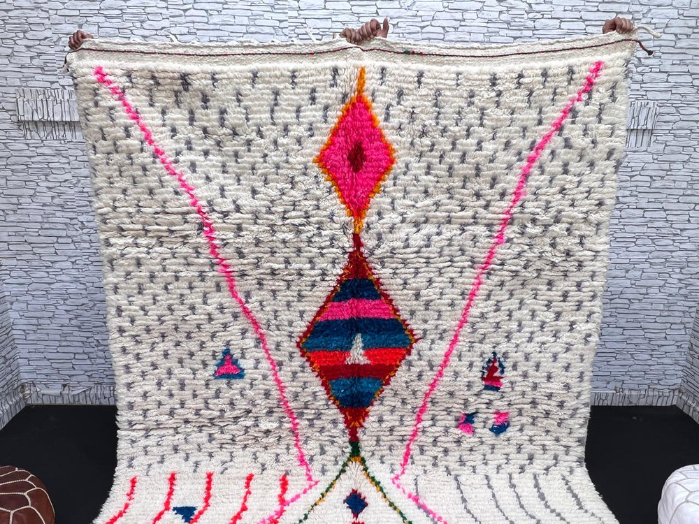 Handmade Moroccan Berber rug with colorful diamond motif on white wool background