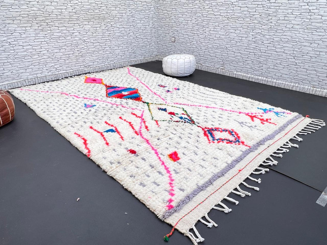 Handmade Moroccan Berber rug with colorful diamond motif on white wool background