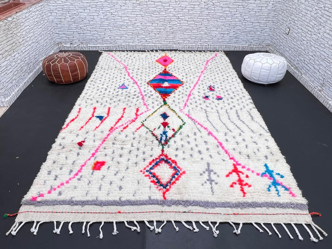 Handmade Moroccan Berber rug with colorful diamond motif on white wool background