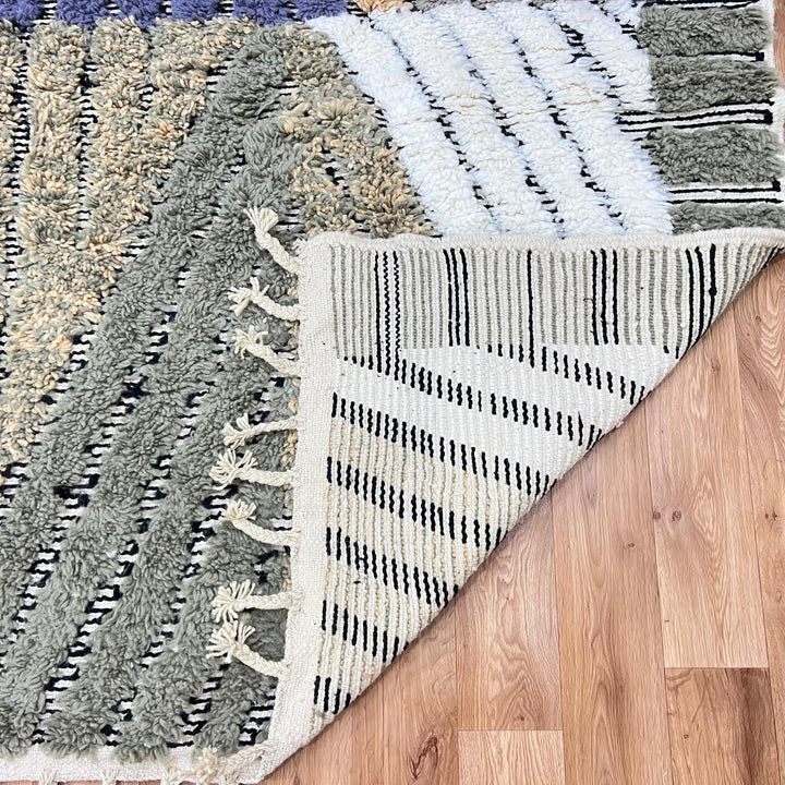 Modern Moroccan wool runner rug with carved black lines, abstract geometric design in ivory, beige, green and grey, handmade Berber carpet