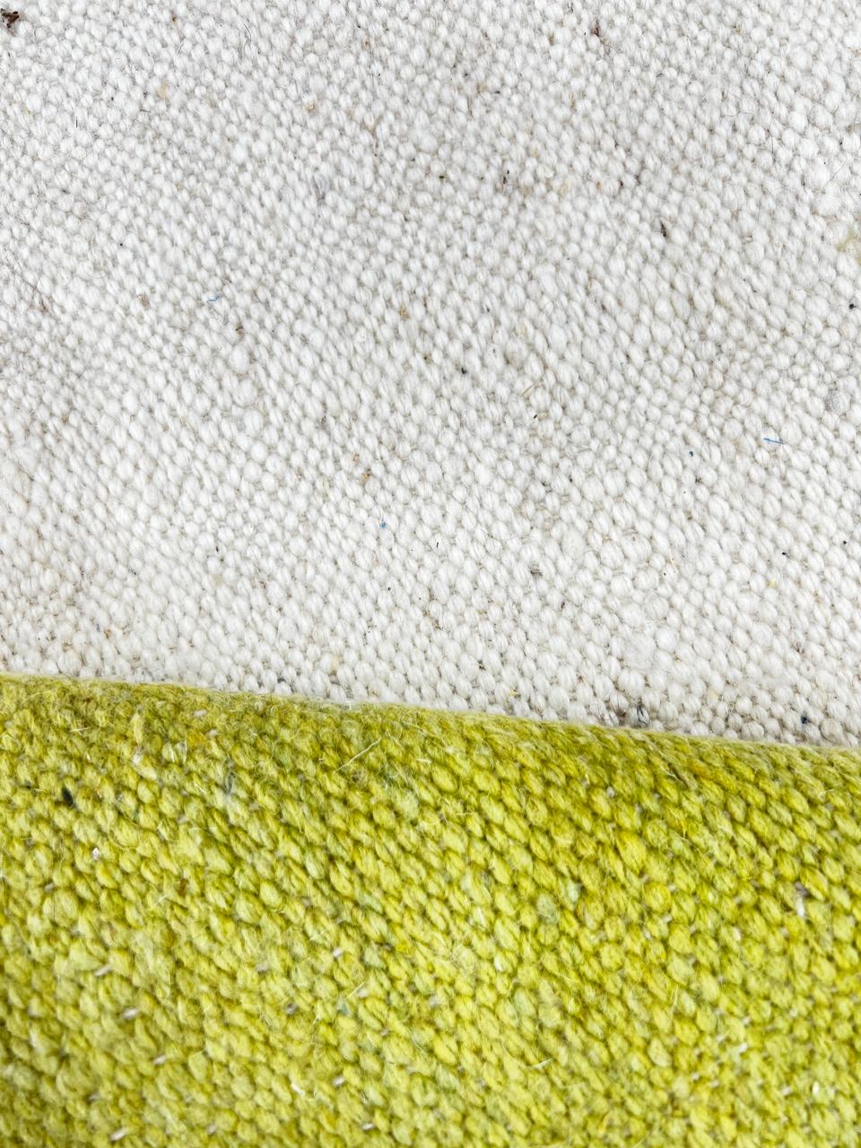 Flat-weave round Moroccan wool rug with ivory base and terracotta and yellow abstract design