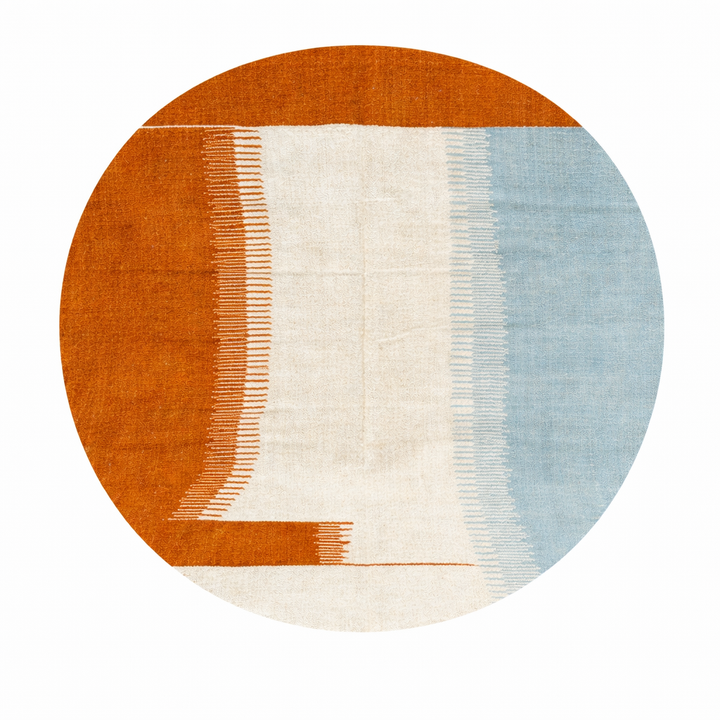 Flat weave round Moroccan wool rug with modern abstract design in terracotta, ivory, and soft blue tones