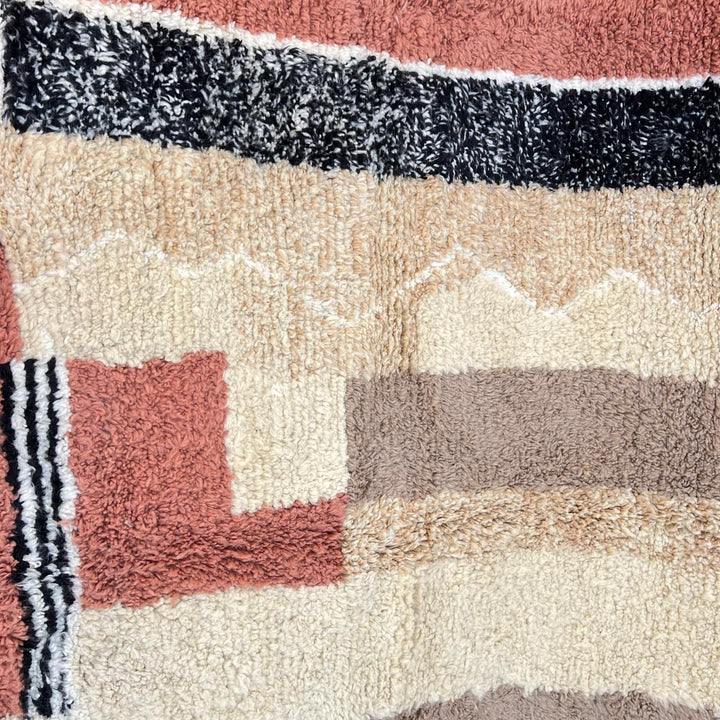 Modern round Moroccan wool rug with handmade Berber geometric design in beige, terracotta, and black