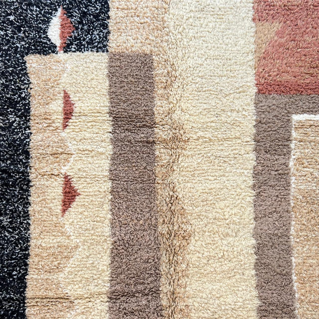 Modern round Moroccan wool rug with handmade Berber geometric design in beige, terracotta, and black