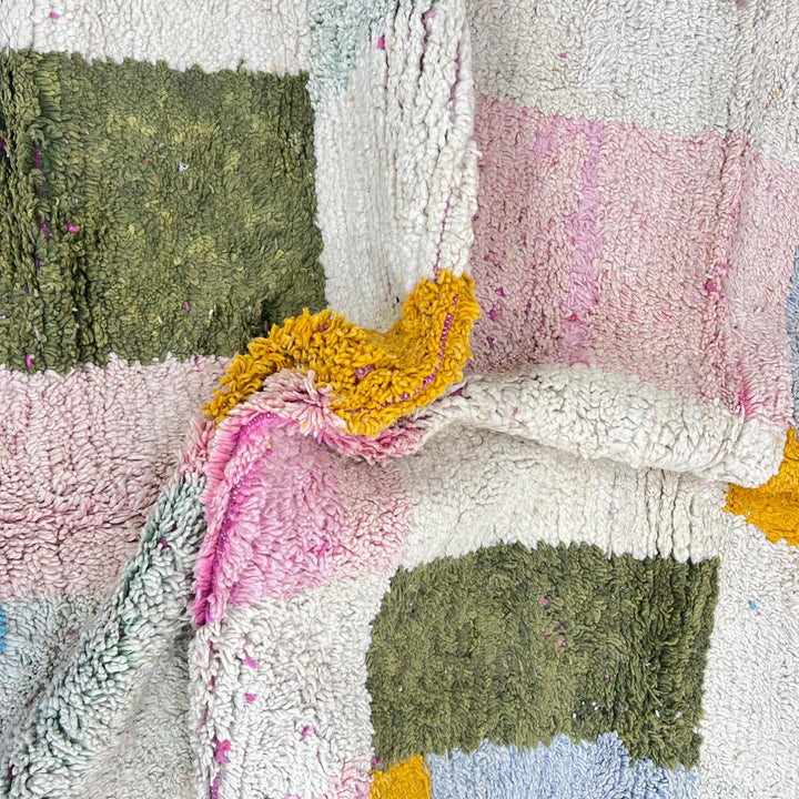Vintage Moroccan wool rug with soft pastel geometric color-block design in ivory, pink, green, and mustard tones, handwoven by Berber artisans