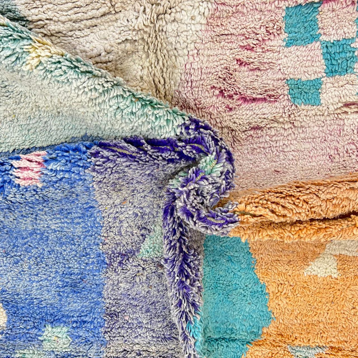 Vintage Moroccan wool rug with colorful geometric Berber patchwork in orange, blue, mint green, lavender and ivory, handmade in Morocco.