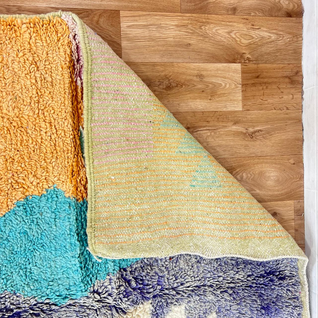 Vintage Moroccan wool rug with colorful geometric Berber patchwork in orange, blue, mint green, lavender and ivory, handmade in Morocco.