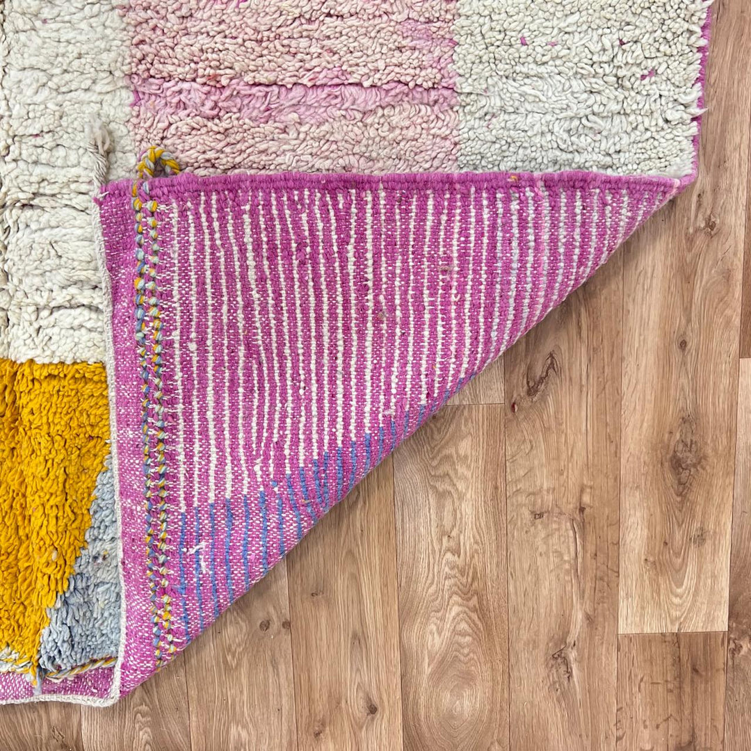 Vintage Moroccan wool rug with soft pastel geometric color-block design in ivory, pink, green, and mustard tones, handwoven by Berber artisans