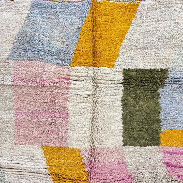 Vintage Moroccan wool rug with soft pastel geometric color-block design in ivory, pink, green, and mustard tones, handwoven by Berber artisans