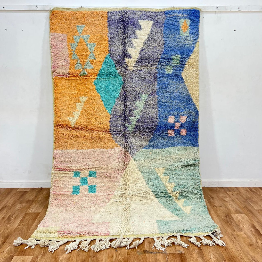 Vintage Moroccan wool rug with colorful geometric Berber patchwork in orange, blue, mint green, lavender and ivory, handmade in Morocco.
