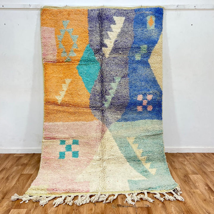 Vintage Moroccan wool rug with colorful geometric Berber patchwork in orange, blue, mint green, lavender and ivory, handmade in Morocco.