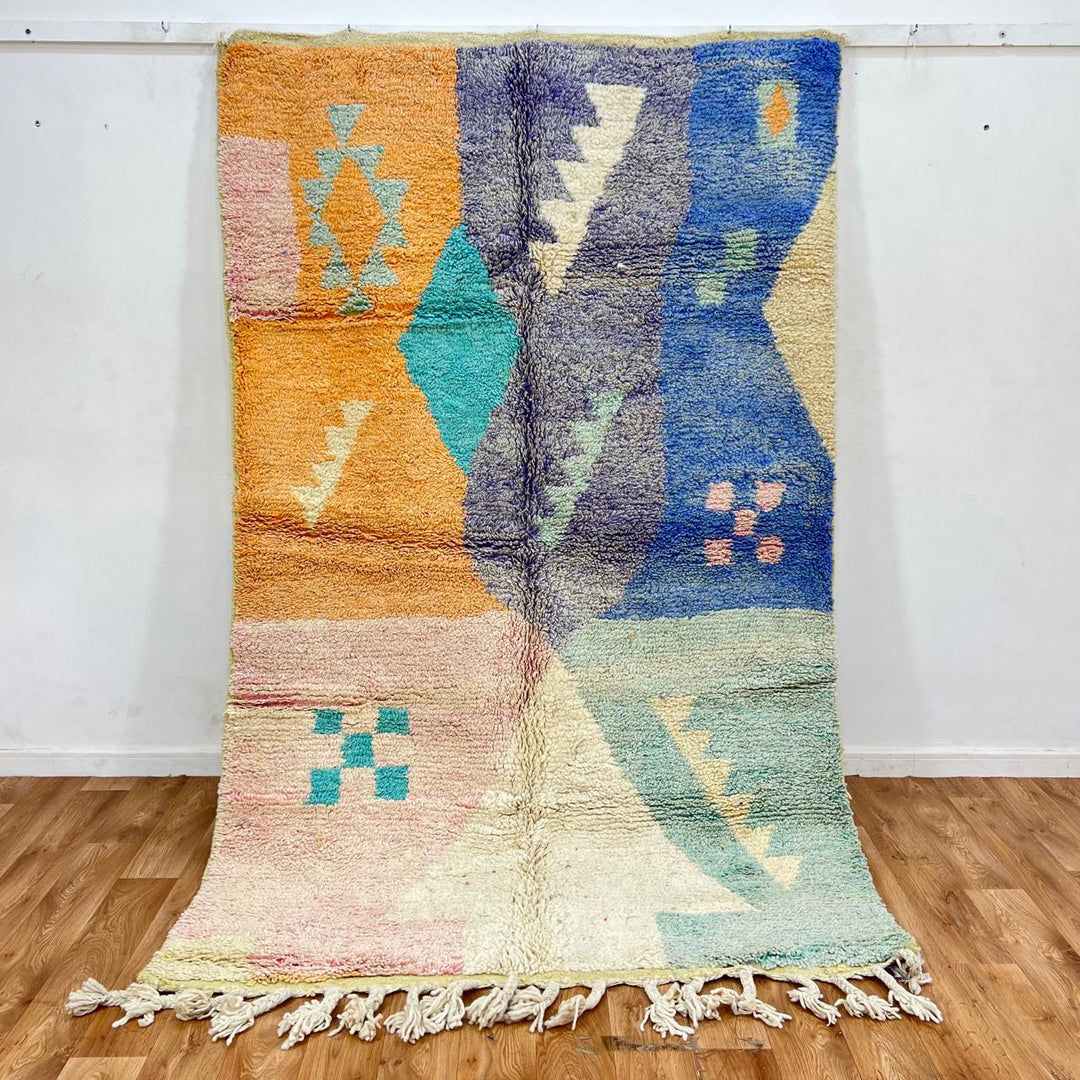 Vintage Moroccan wool rug with colorful geometric Berber patchwork in orange, blue, mint green, lavender and ivory, handmade in Morocco.