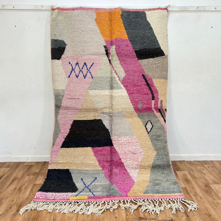 Vintage Moroccan wool rug with abstract geometric Berber design in blush pink, charcoal black, sage green and beige, handmade in Morocco.