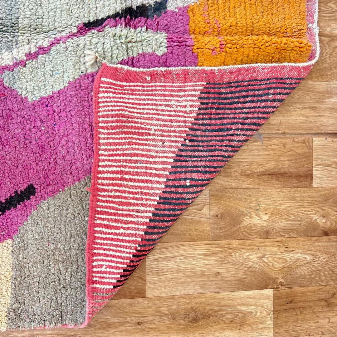 Vintage Moroccan wool rug with abstract geometric Berber design in blush pink, charcoal black, sage green and beige, handmade in Morocco.