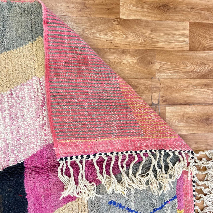 Vintage Moroccan wool rug with abstract geometric Berber design in blush pink, charcoal black, sage green and beige, handmade in Morocco.