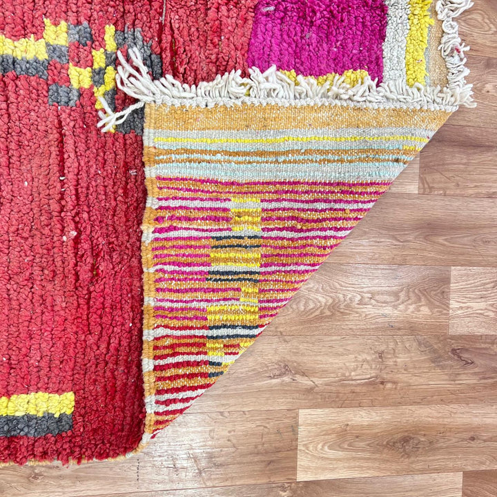 Vintage Moroccan striped wool rug with red pink yellow and gray Berber pattern, handmade in Morocco