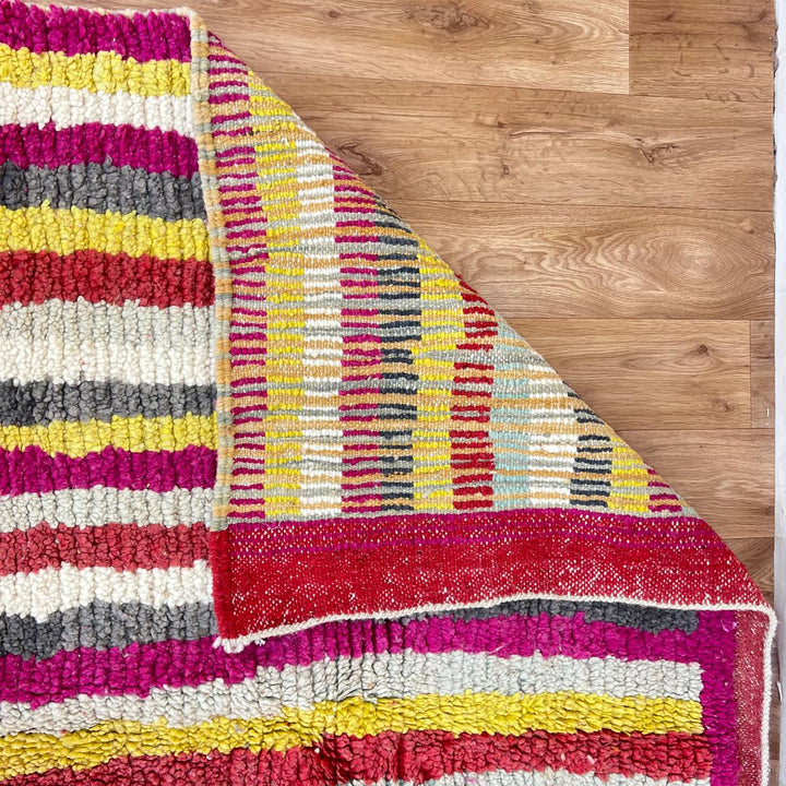 Vintage Moroccan striped wool rug with red pink yellow and gray Berber pattern, handmade in Morocco