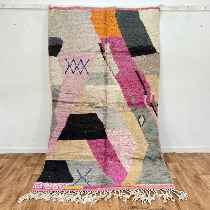 Vintage Moroccan wool rug with abstract geometric Berber design in blush pink, charcoal black, sage green and beige, handmade in Morocco.