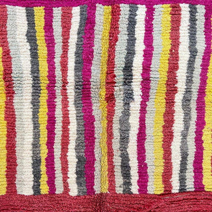 Vintage Moroccan striped wool rug with red pink yellow and gray Berber pattern, handmade in Morocco