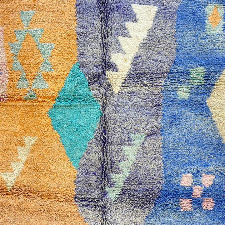 Vintage Moroccan wool rug with colorful geometric Berber patchwork in orange, blue, mint green, lavender and ivory, handmade in Morocco.