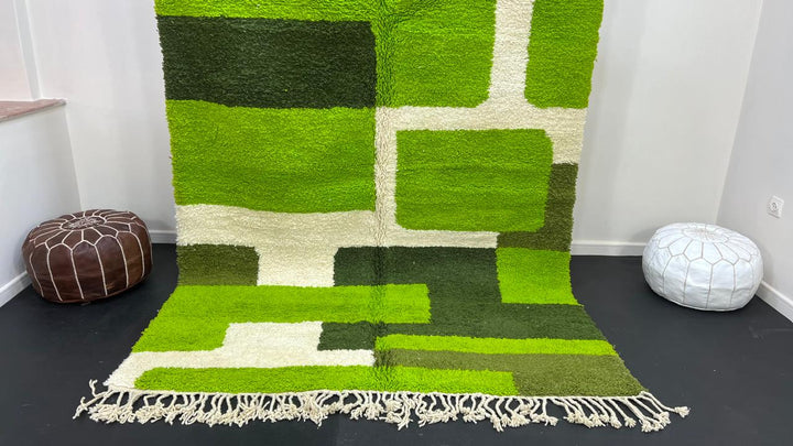 Modern green Moroccan wool rug with geometric Berber pattern and white lines on white background