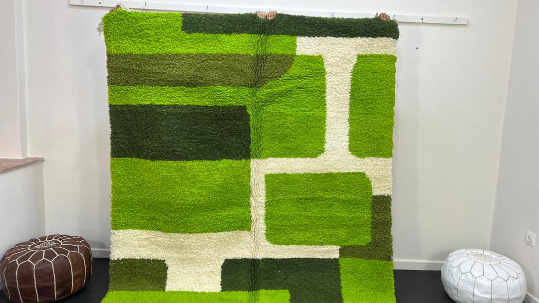 Modern green Moroccan wool rug with geometric Berber pattern and white lines on white background