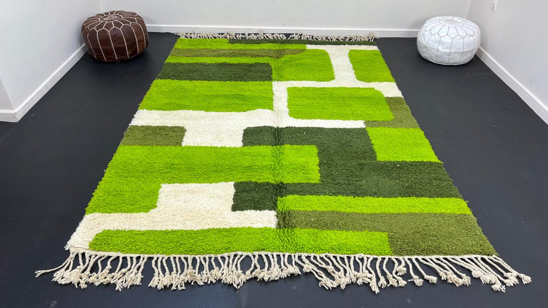 Modern green Moroccan wool rug with geometric Berber pattern and white lines on white background