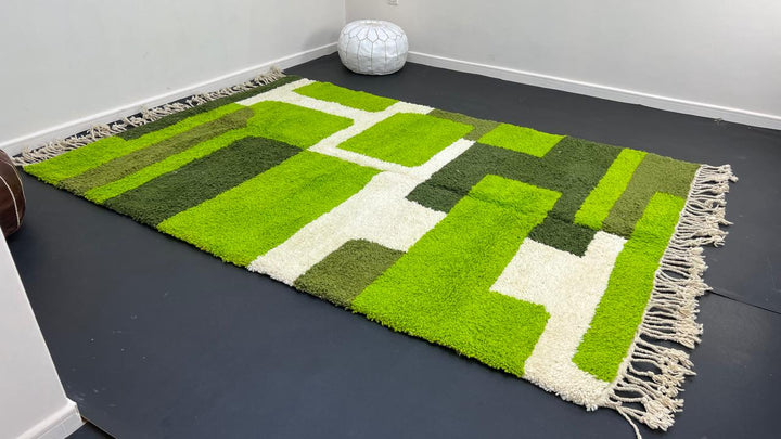 Modern green Moroccan wool rug with geometric Berber pattern and white lines on white background