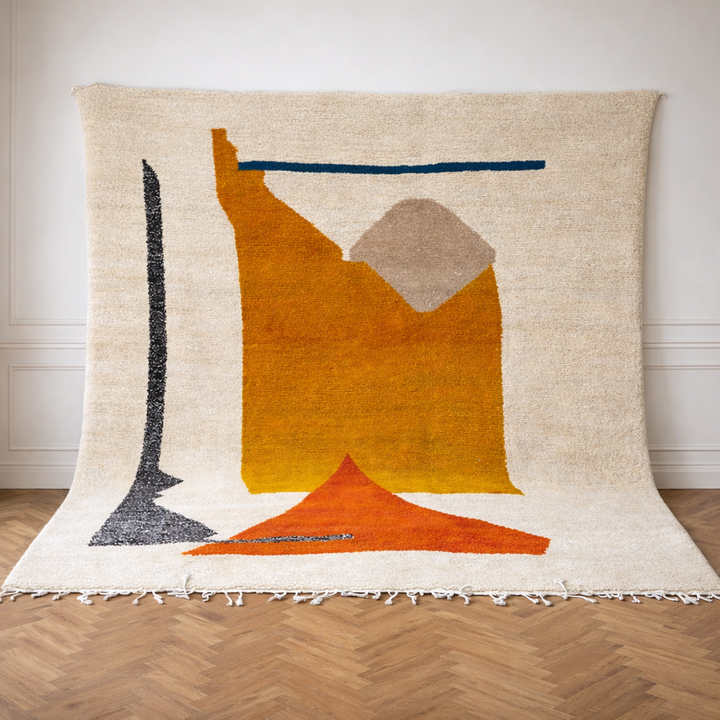 Handmade modern Moroccan wool rug in cream with mustard yellow and terracotta geometric Berber design, plush shag texture with tassels