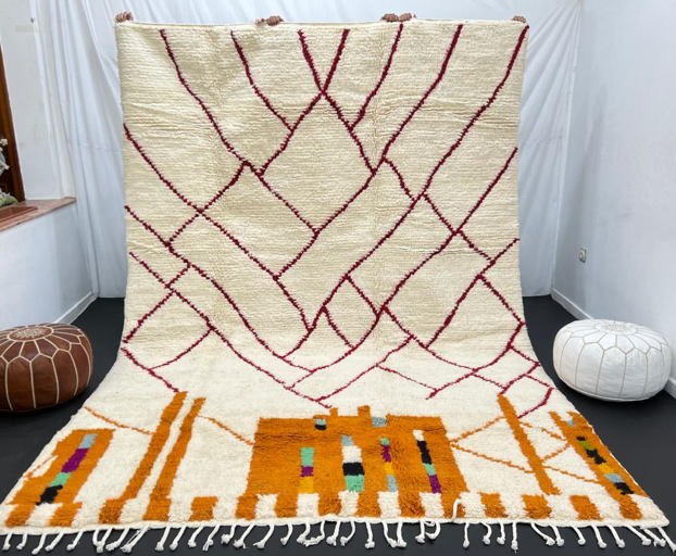 Modern Moroccan wool rug with abstract burgundy lines and golden geometric pattern on a white background