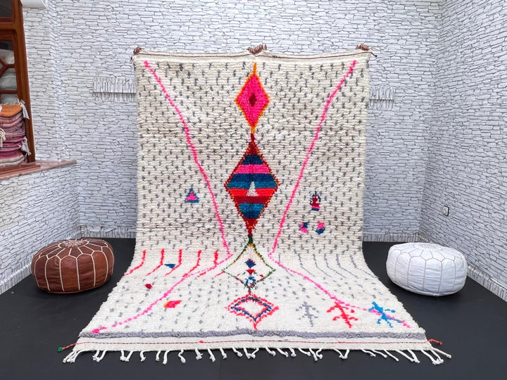Handmade Moroccan Berber rug with colorful diamond motif on white wool background