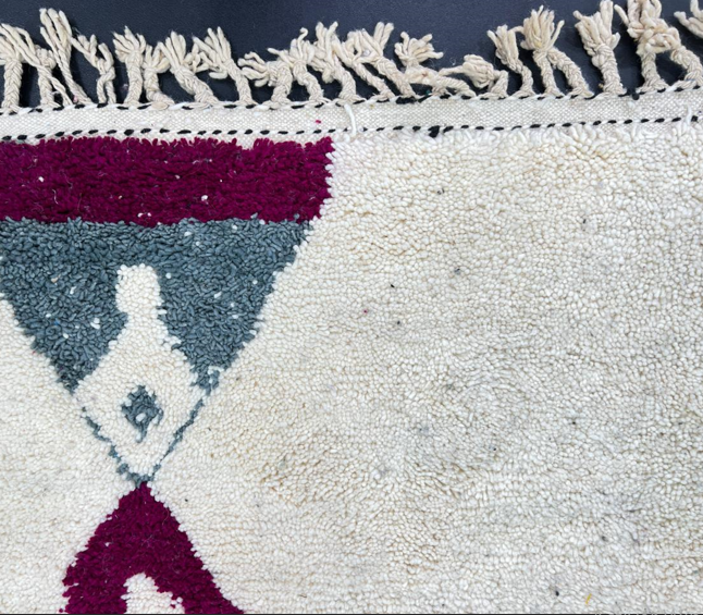 Handmade modern Moroccan wool runner rug with black, green, mint, grey, and magenta geometric abstract patterns on a white background