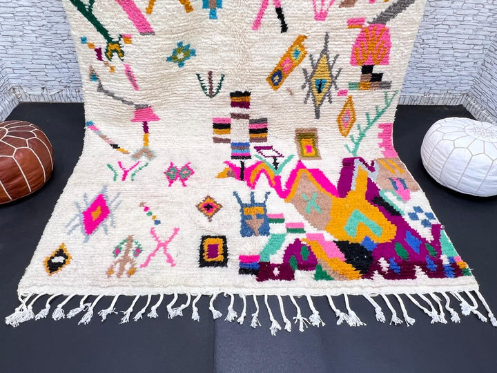 Natural white Moroccan Berber wool rug with colorful symbolic patterns