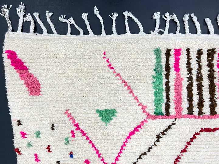 Handwoven colorful Moroccan wool runner rug with pink, green, and blue geometric Berber patterns