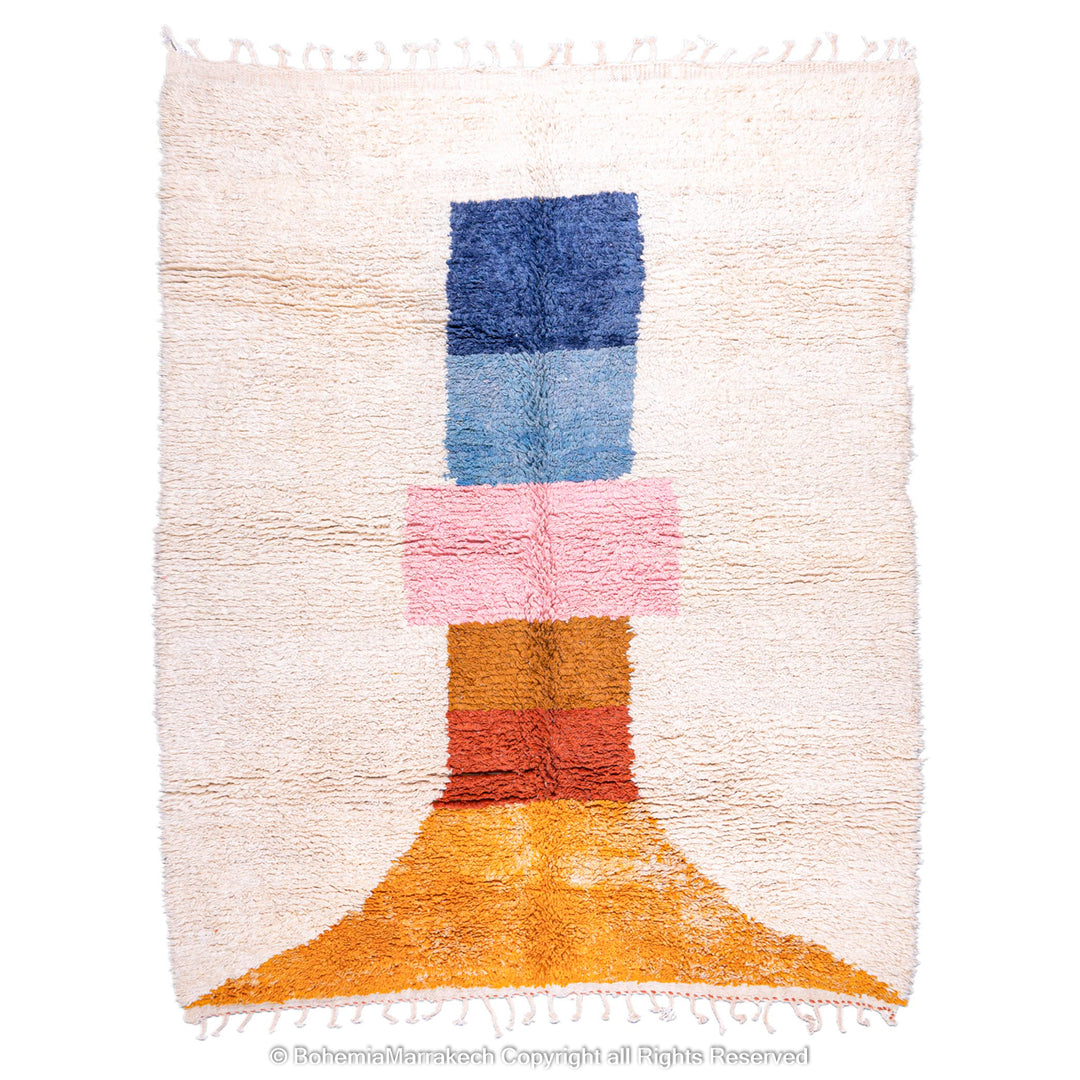 Handmade Moroccan rug with colorful geometric design, featuring blue, pink, orange blocks on wool shag carpet.