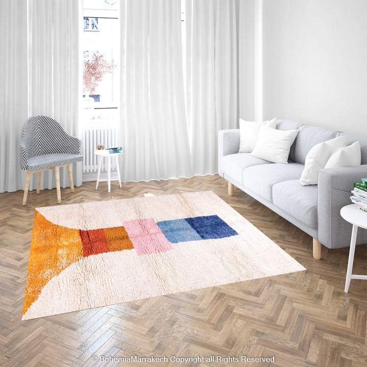 Colorful handmade Moroccan wool rug in geometric design on living room floor.