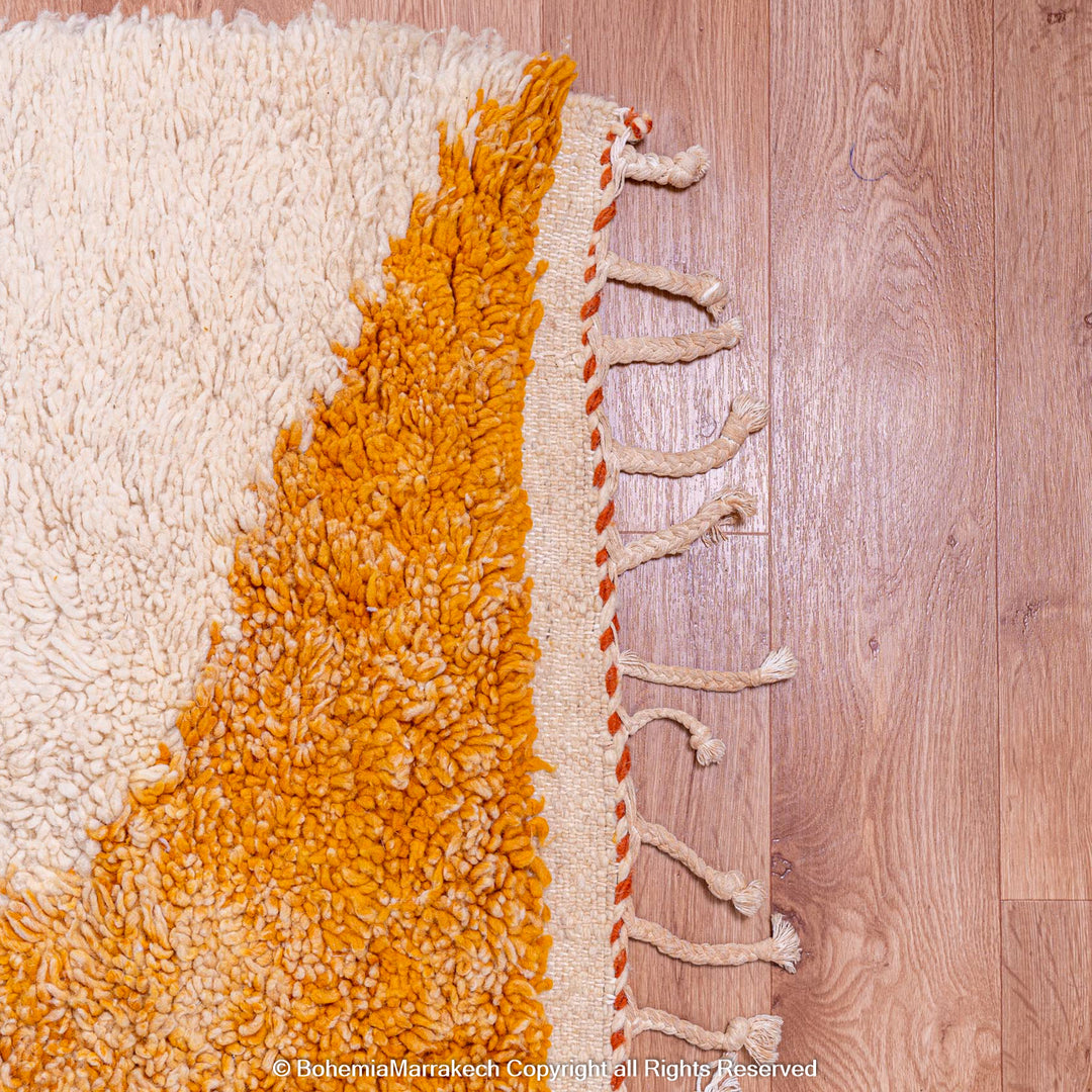 Moroccan wool shag rug with orange and cream geometric design, ideal as a traditional Moroccan carpet for living rooms.