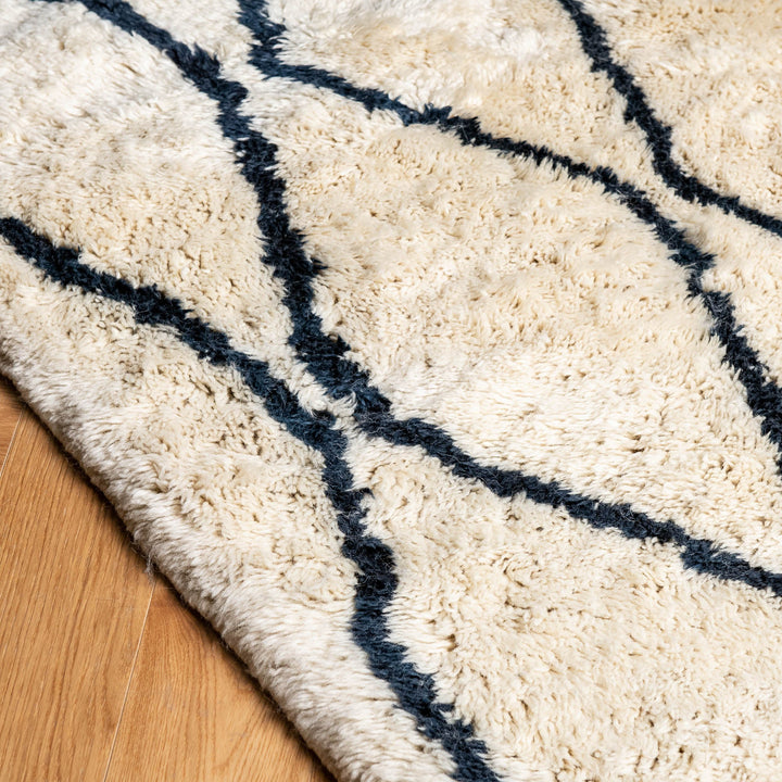 Moroccan Cream Wool Rug with Wavy Black Line Pattern