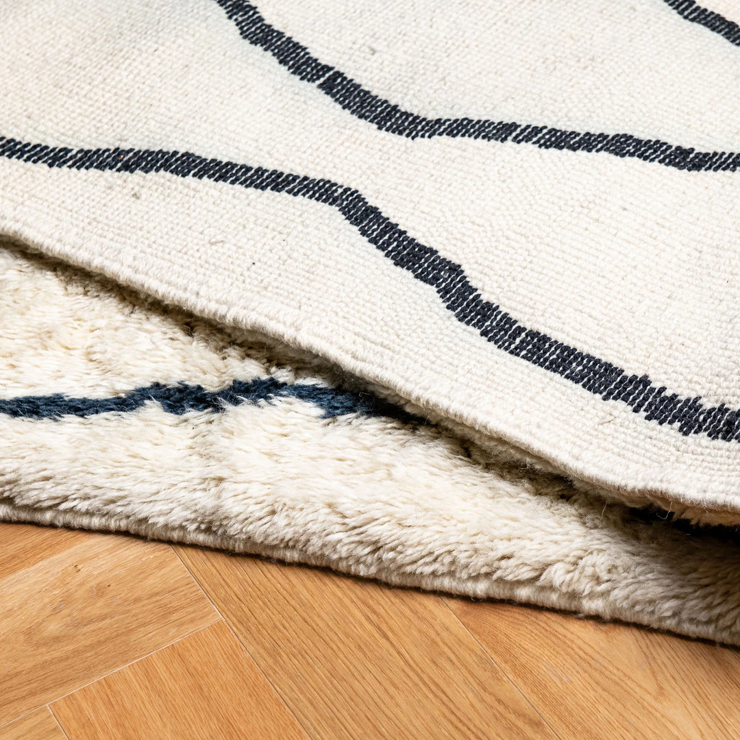 Moroccan Cream Wool Rug with Wavy Black Line Pattern