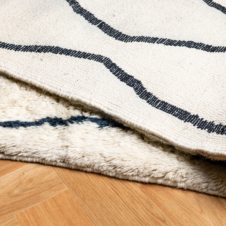 Moroccan Cream Wool Rug with Wavy Black Line Pattern