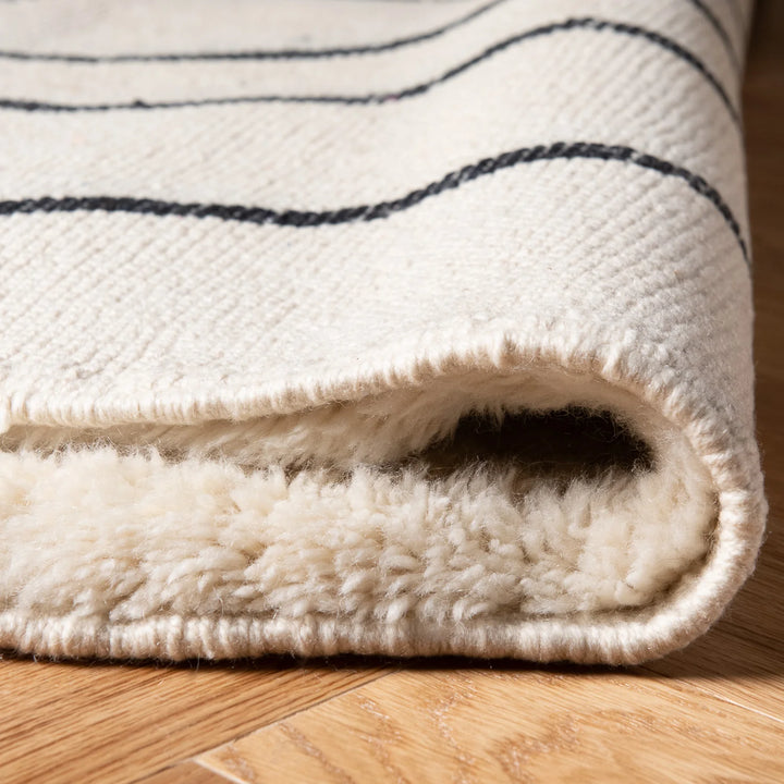 Moroccan Cream Wool Rug with Wavy Black Line Pattern