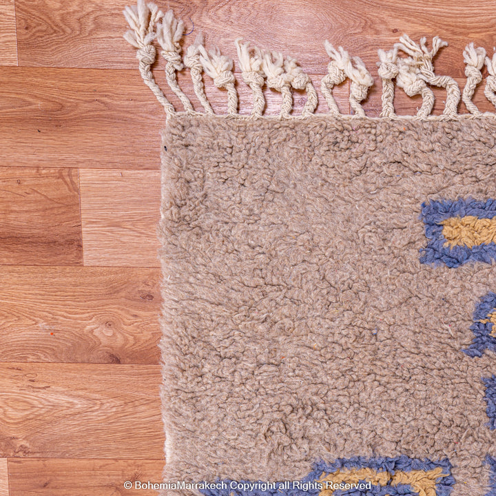Modern handmade Moroccan wool rug in brown with Berber-style abstract border design