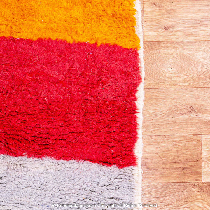 Handmade Beni Ourain Moroccan rug in sunset colors with saffron, red, ivory, and black block pattern
