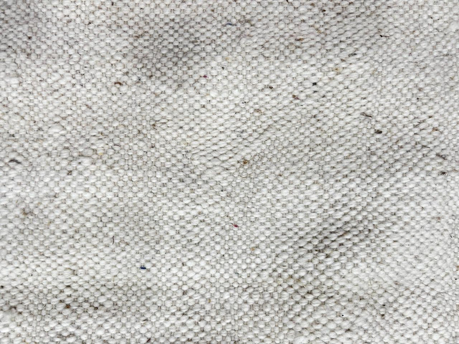 Handmade Moroccan kilim flatweave wool rug with round shape and soft geometric Berber design on ivory background