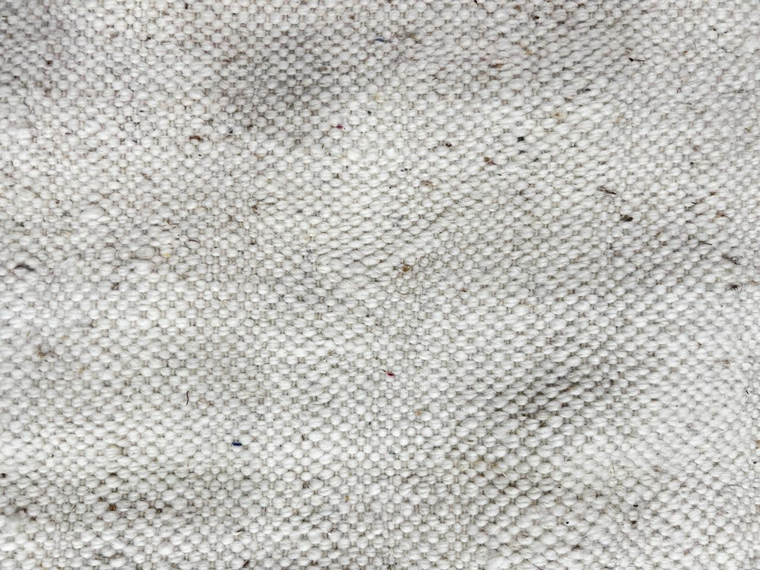 Handmade Moroccan kilim flatweave wool rug with round shape and soft geometric Berber design on ivory background